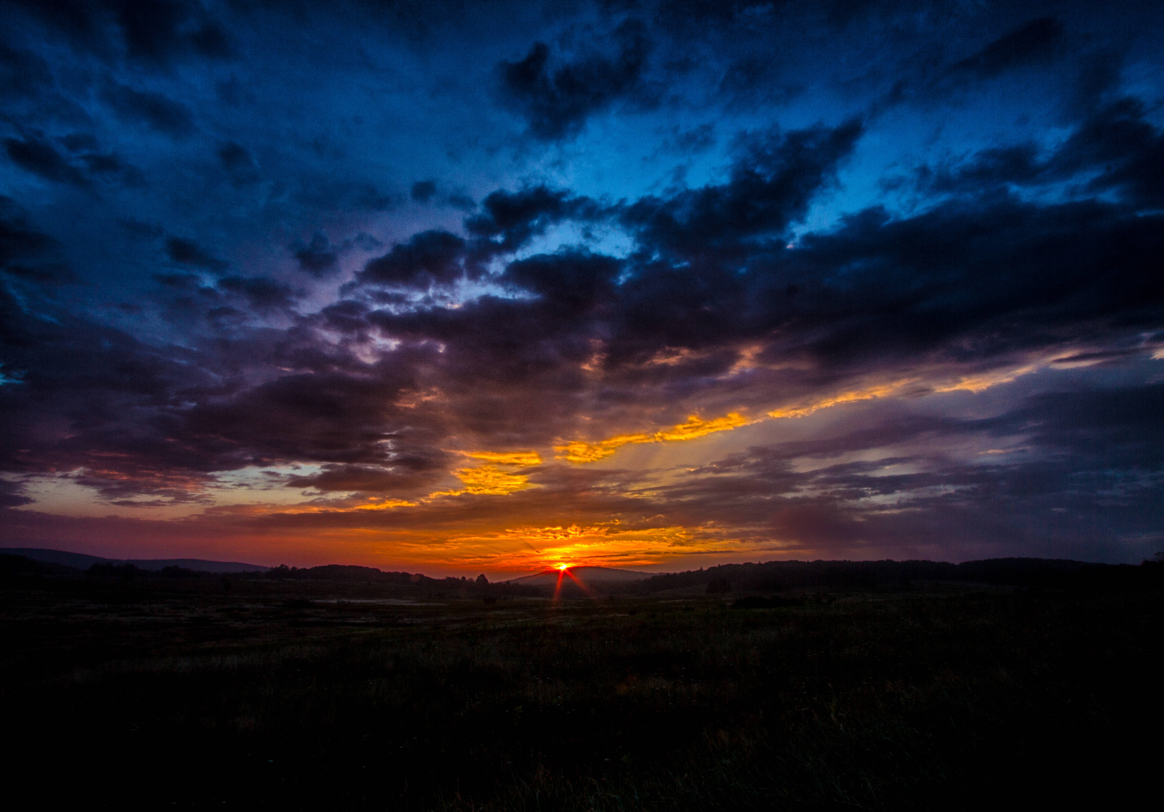 Contempla la belleza de las montañas oscuras en este hermoso amanecer naranja Fondos de pantalla