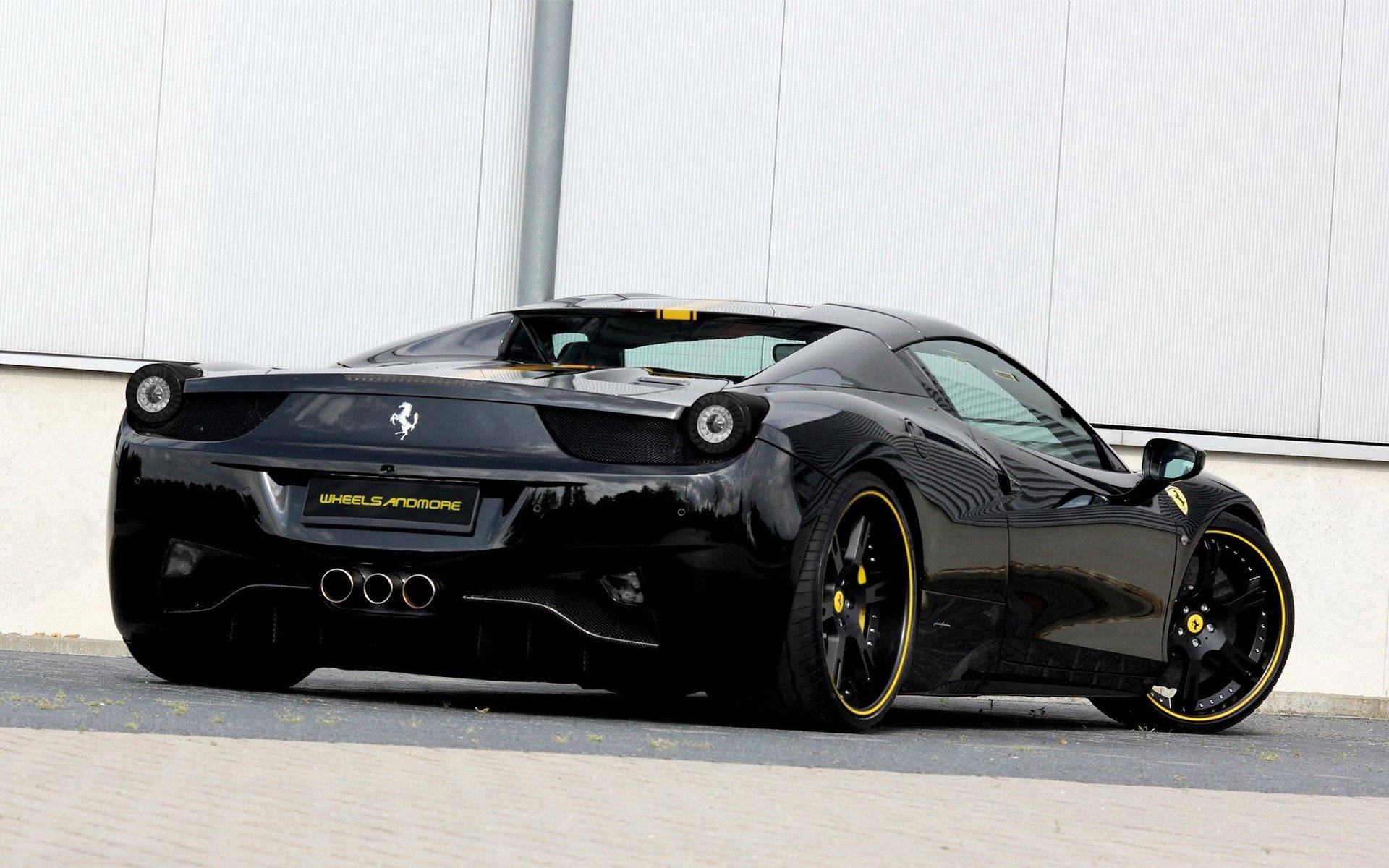 Fondo de pantalla del Ferrari 458 Italia negro vista trasera con acentos amarillos.