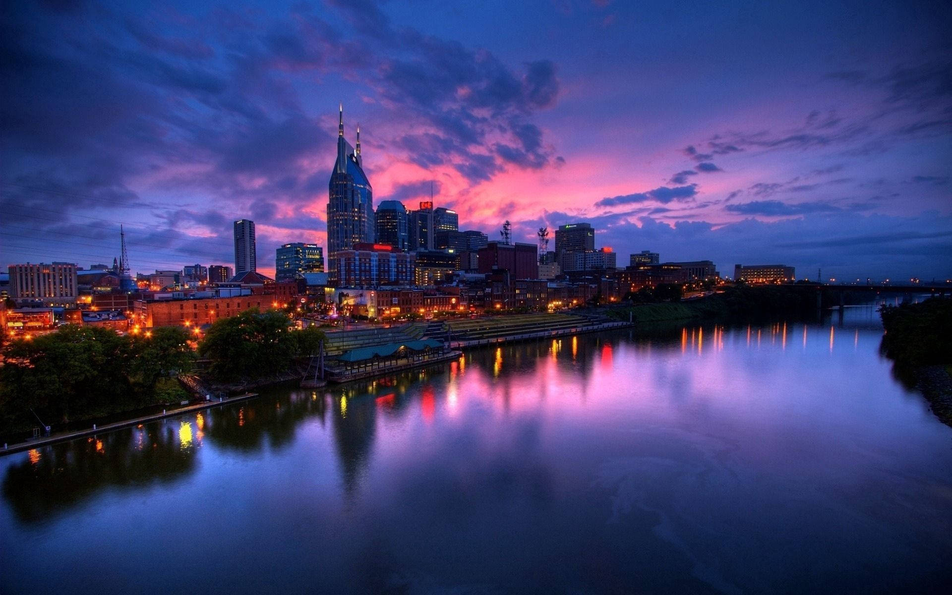 Ciudad y reflejo del cielo morado junto al río.