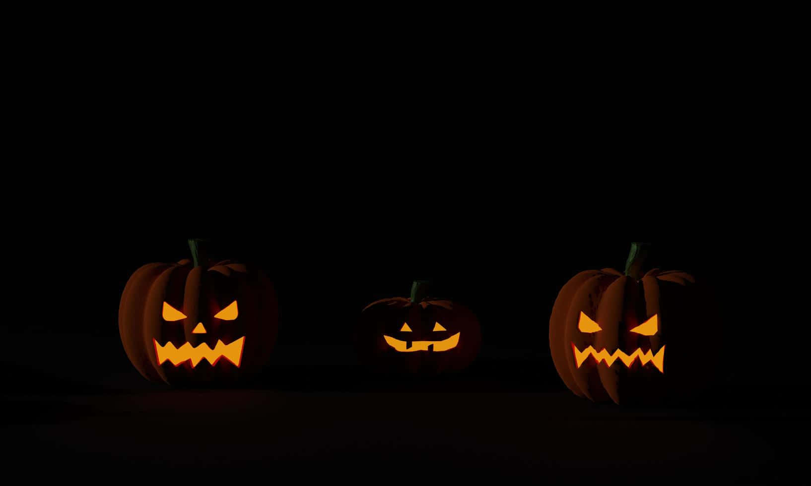 Fondo oscuro de tres calabazas de Halloween Fondos de pantalla