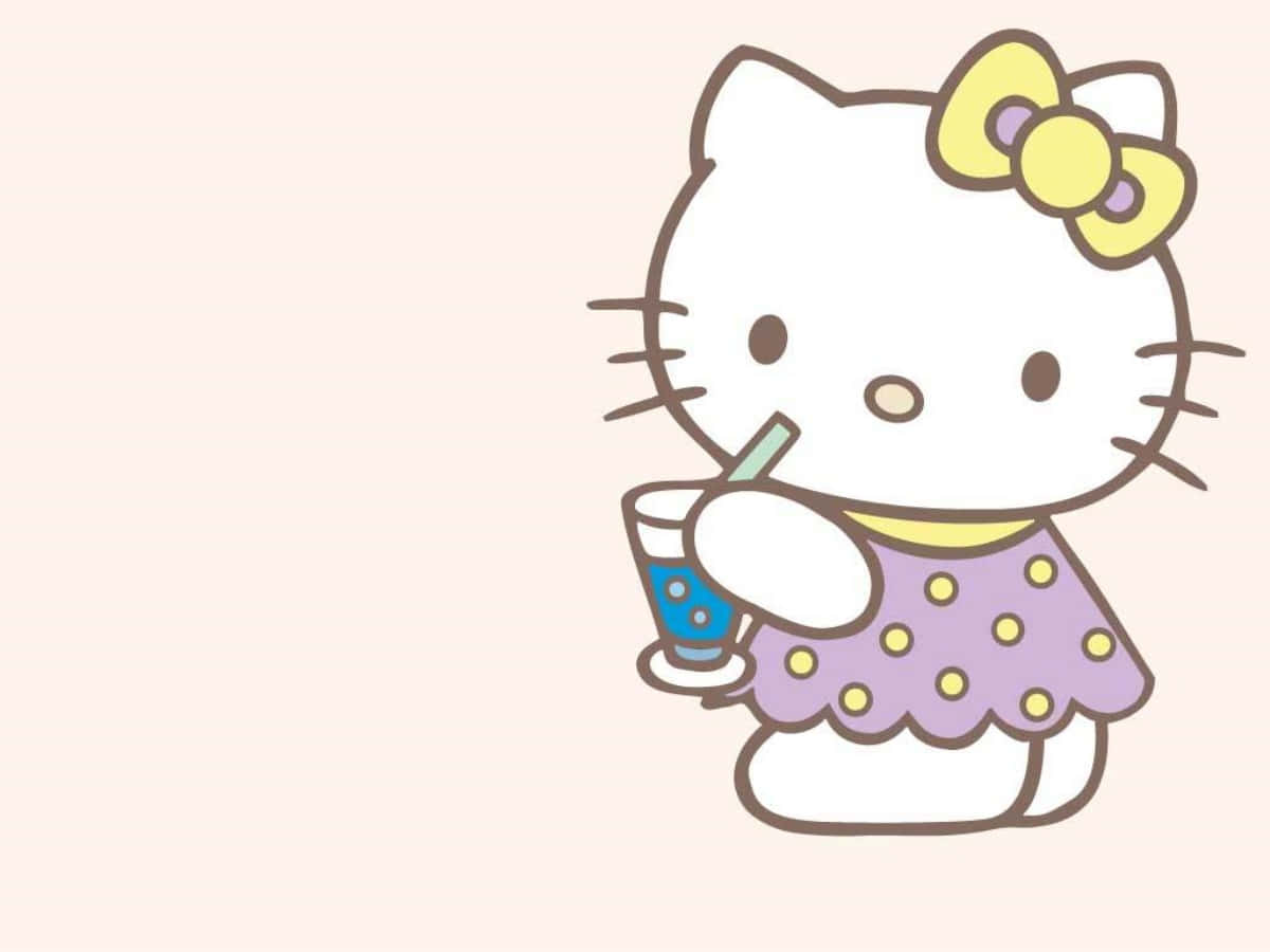 Hello Kitty sorbiendo una bebida en laptop Fondos de pantalla