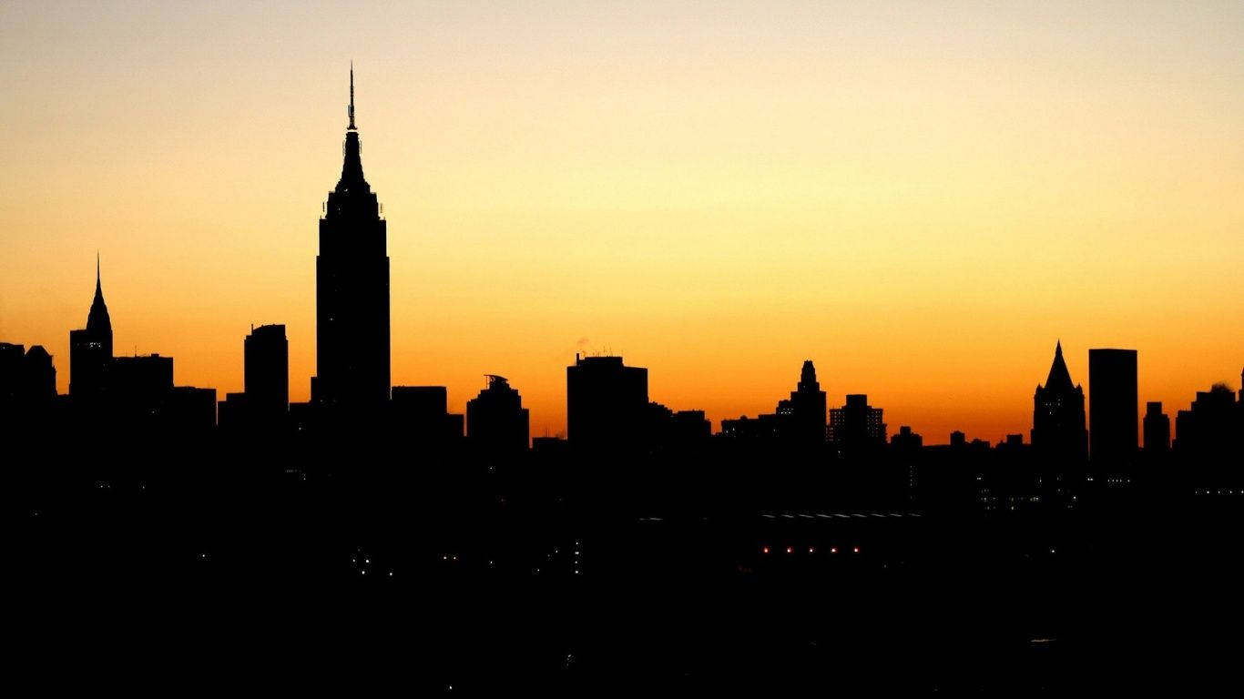 Hermosa Silueta de Ciudad Naranja al Anochecer Fondos de pantalla