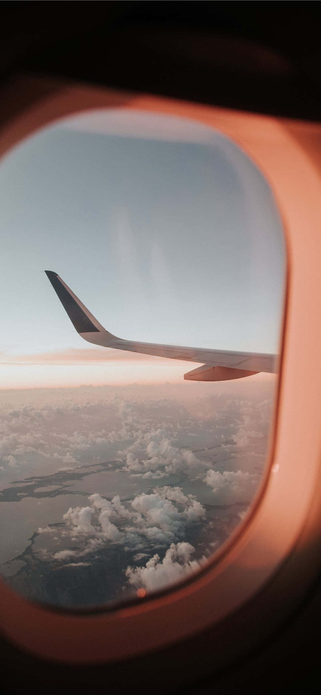 un ala de avión vista a través de la ventana de un avión Fondos de pantalla