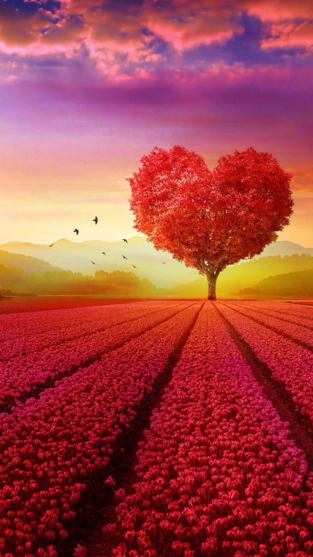 un árbol con forma de corazón rojo en un campo de flores Fondos de pantalla