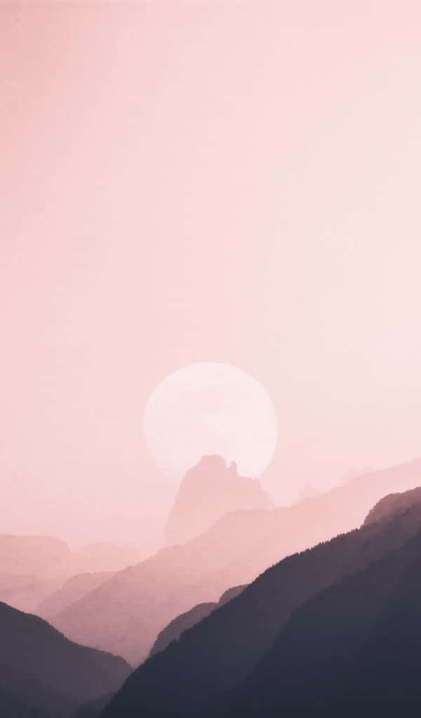 Un atardecer rosa sobre montañas y colinas Fondos de pantalla