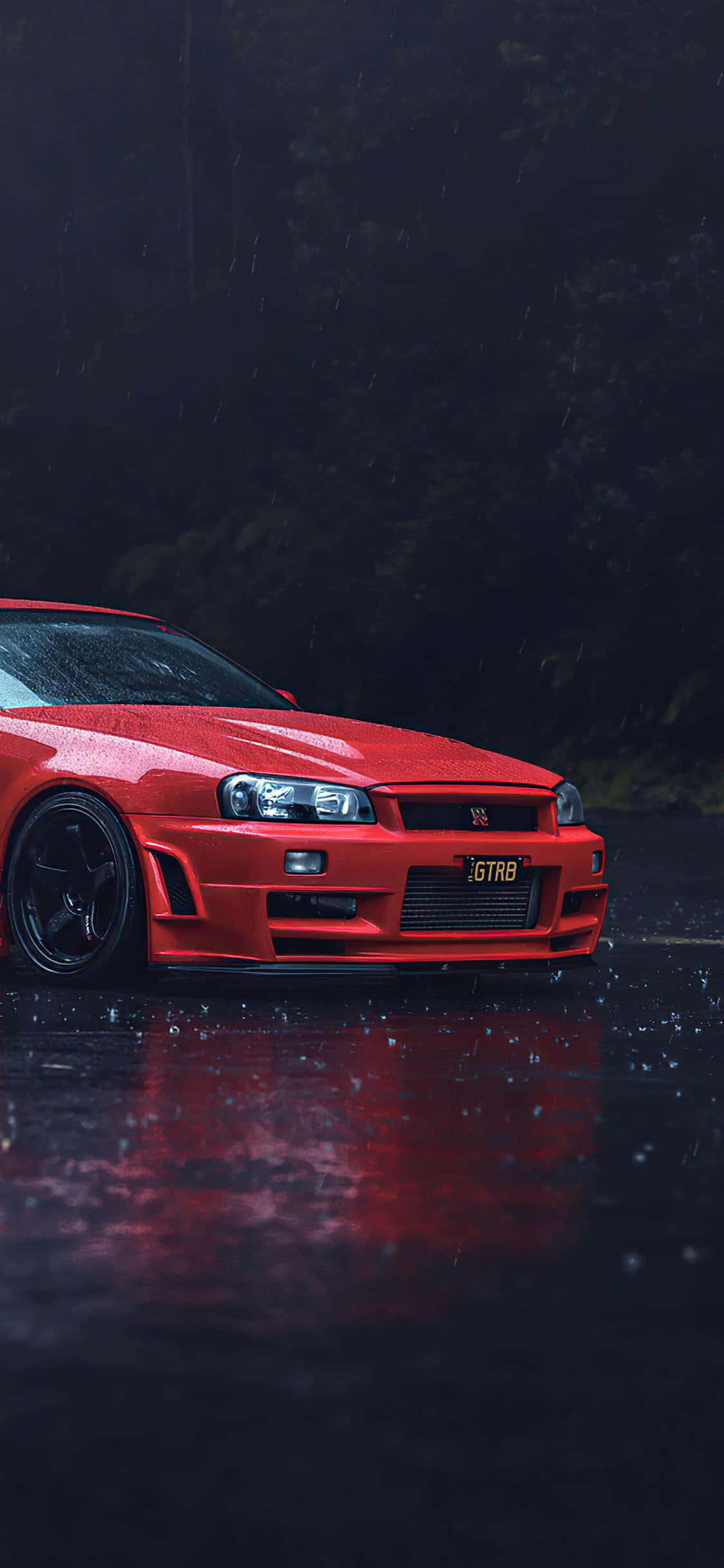 un coche rojo está estacionado bajo la lluvia Fondos de pantalla