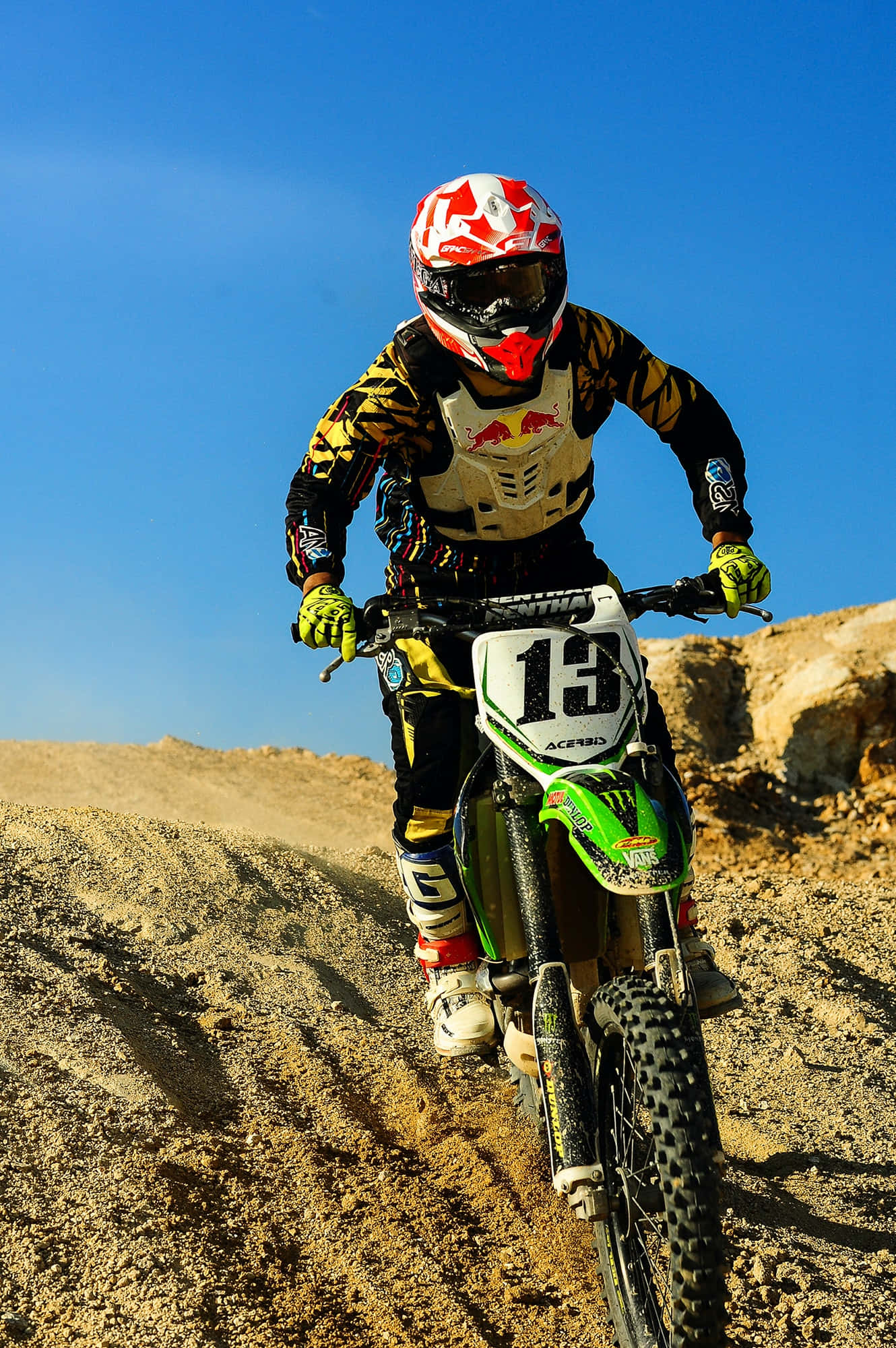 Un corredor de motocross salta alto contra un cielo despejado Fondos de pantalla