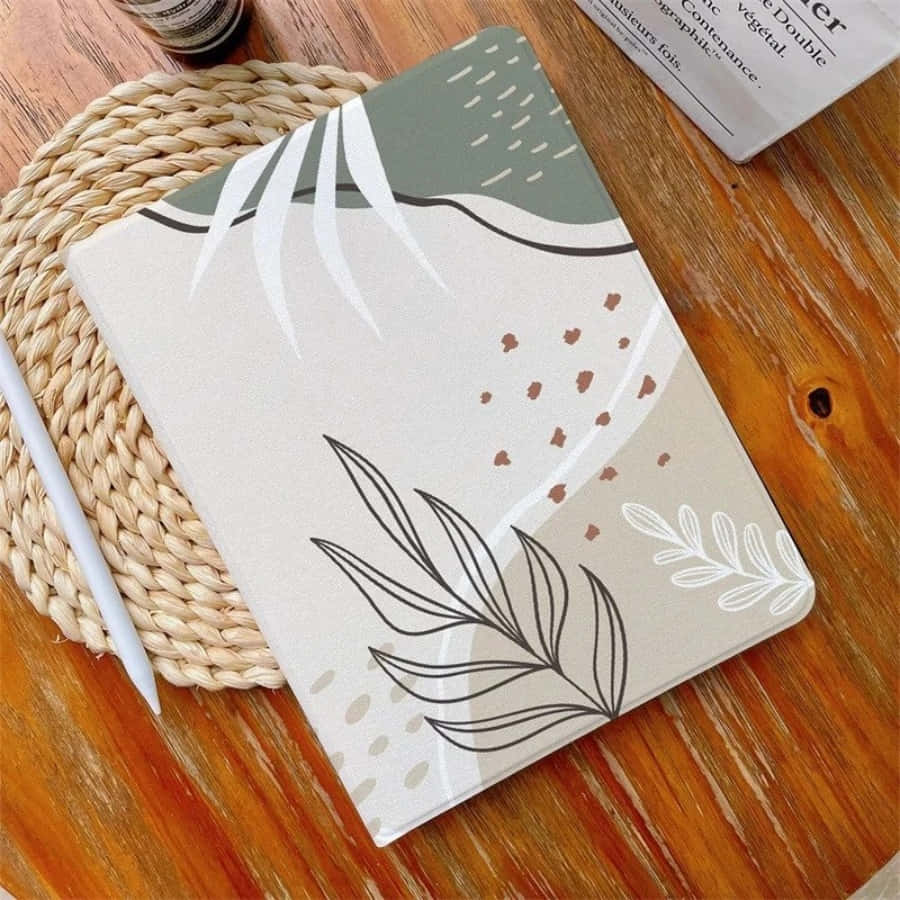 un cuaderno con un diseño de hoja Fondos de pantalla