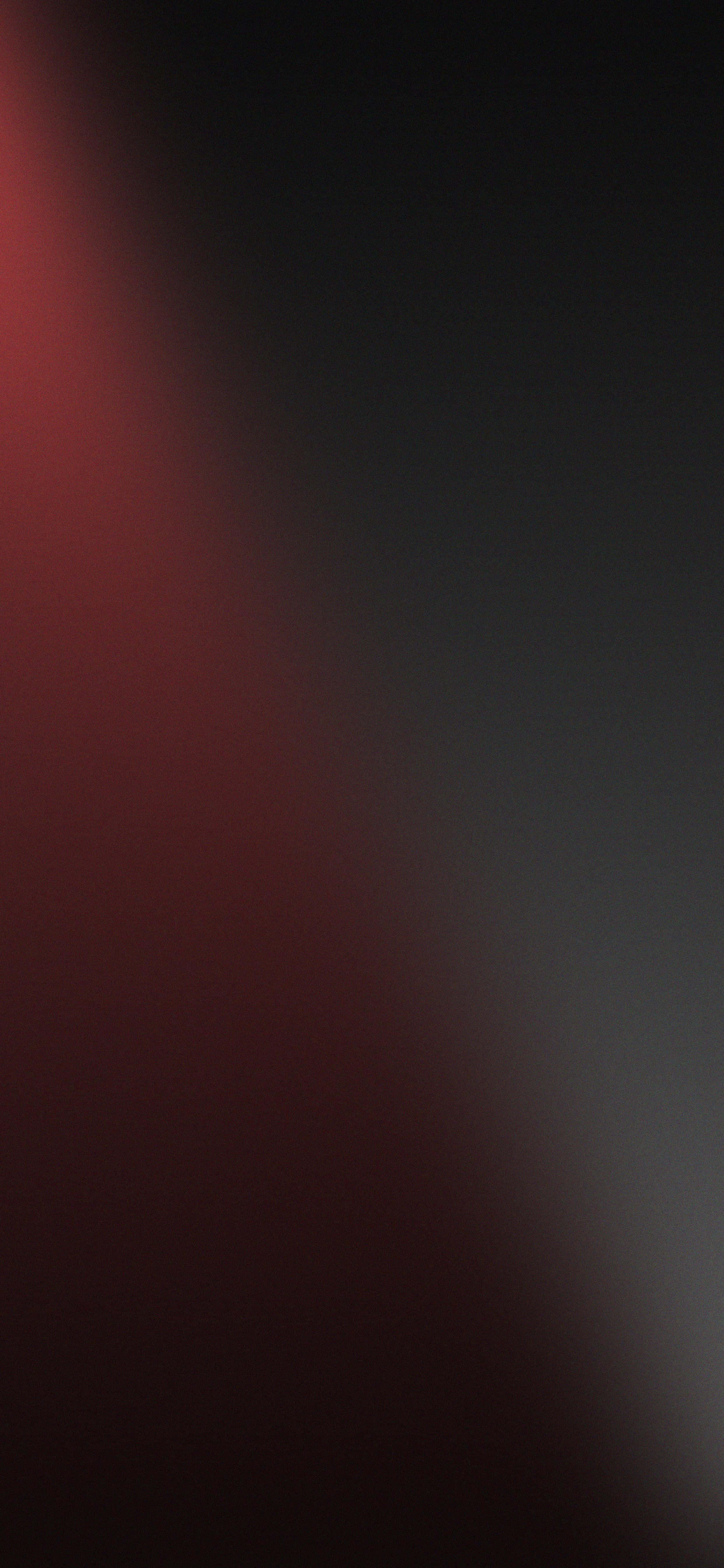 un fondo negro y rojo con una luz brillando sobre él Fondos de pantalla