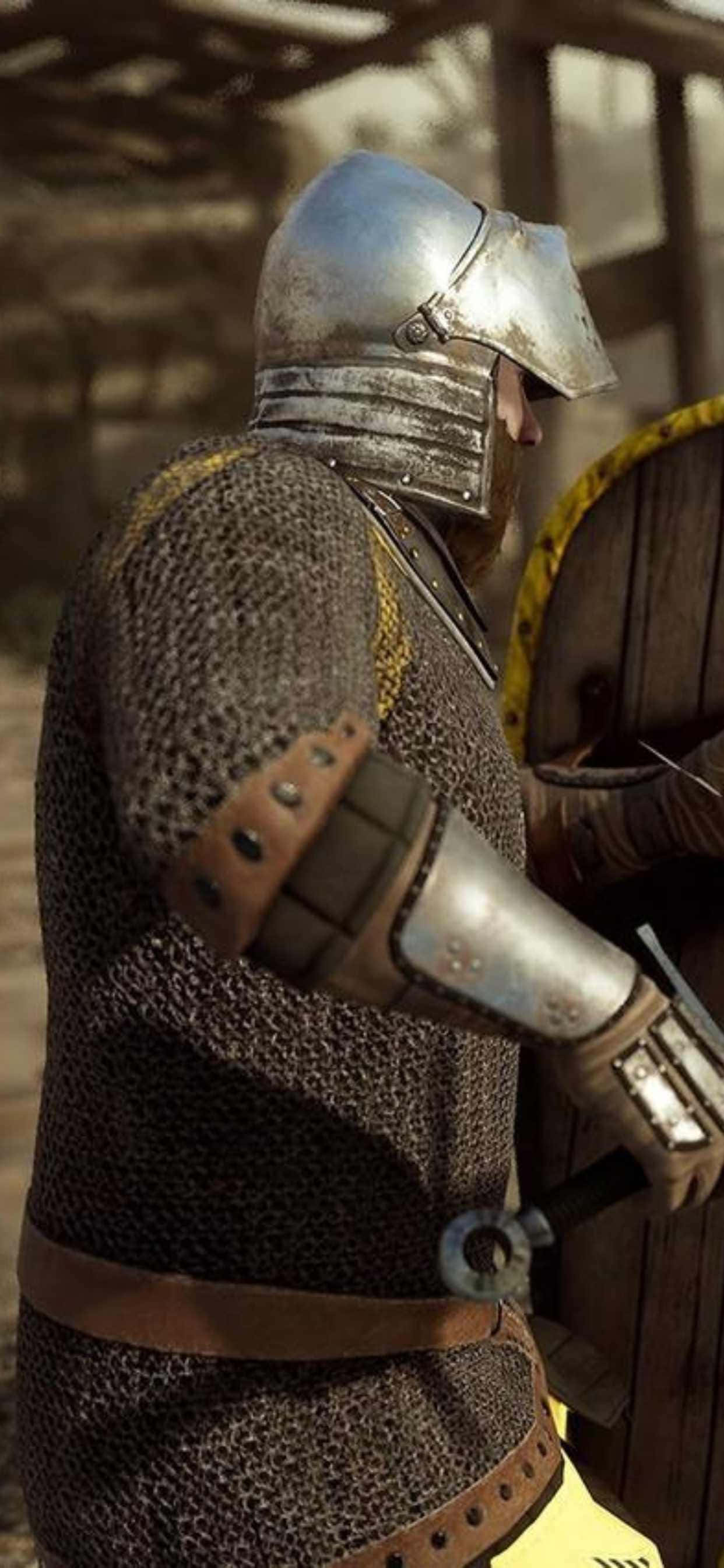 un hombre con armadura medieval sostiene un escudo Fondos de pantalla