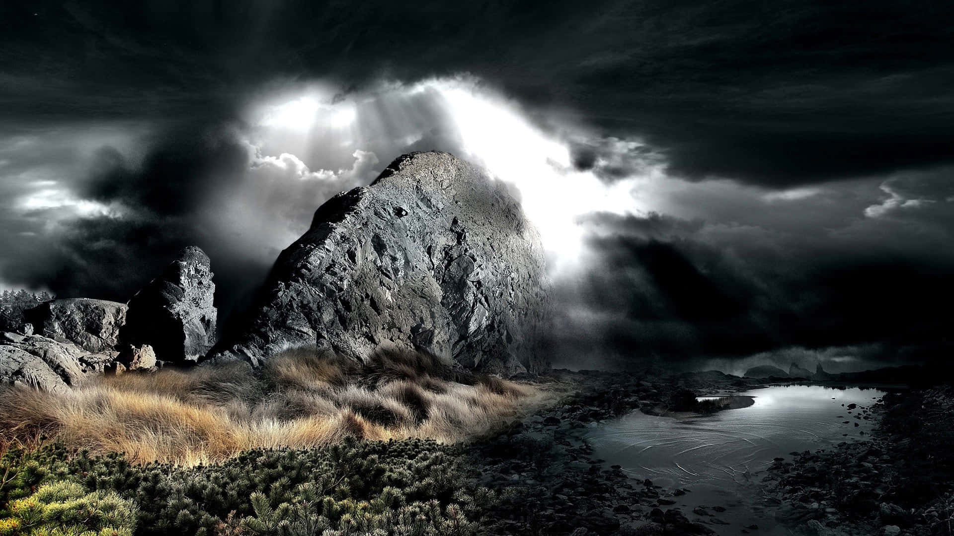 un paisaje oscuro con cielo tormentoso y rocas Fondos de pantalla