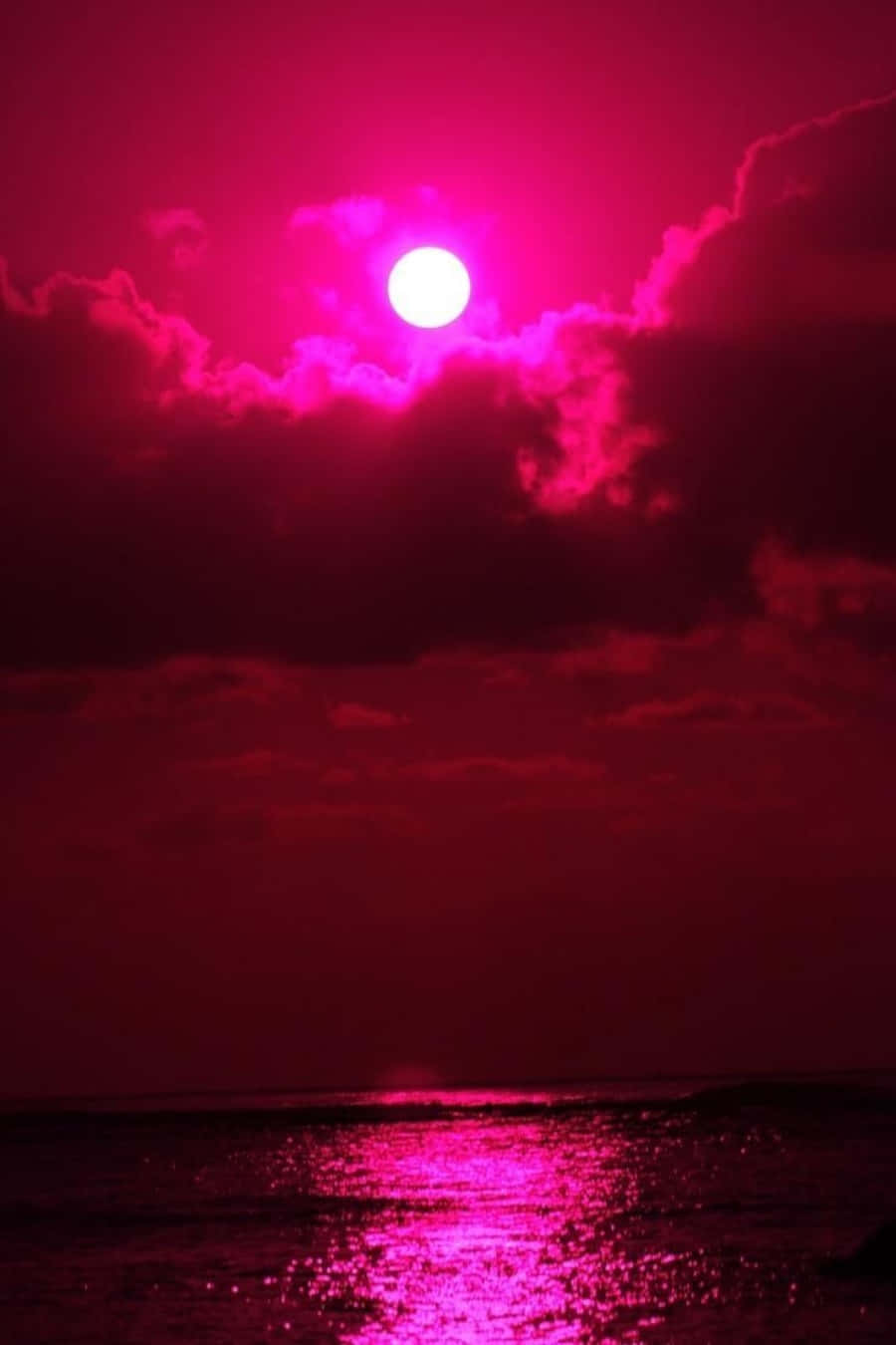 un sol rosa sobre el océano Fondos de pantalla