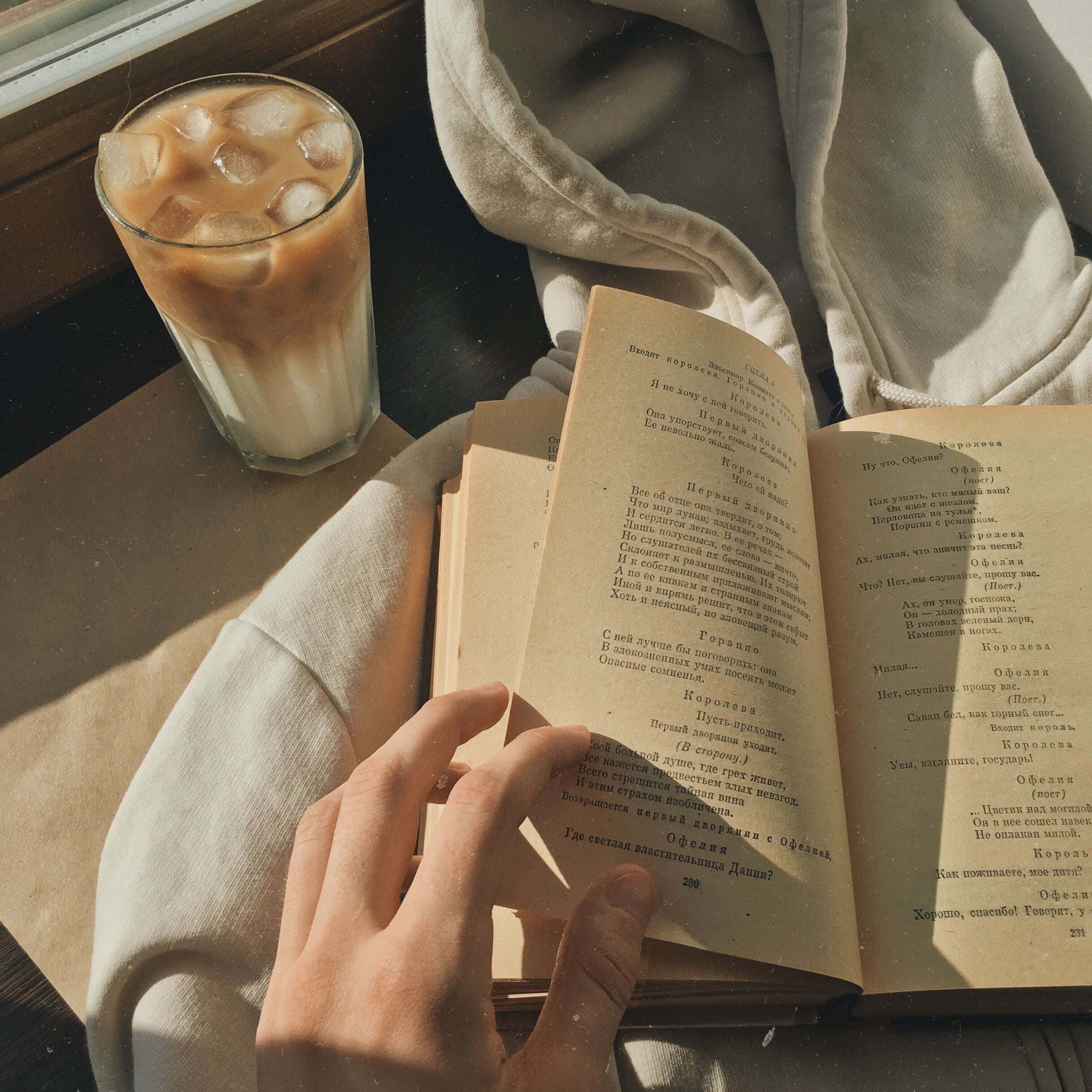 una persona leyendo un libro con una taza de café Fondos de pantalla
