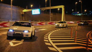 Autos JDM corriendo en la ciudad de noche