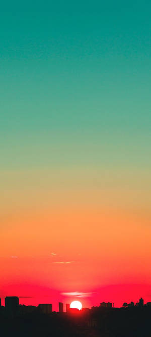 Fondo de pantalla de cielo al atardecer en verde azulado y rojo — iPhone 16 Pro Fondos de pantalla