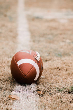 Fondo de pantalla móvil de balón de fútbol americano.