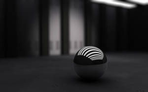 Fondo de pantalla de escritorio 3D de una pequeña esfera negra.
