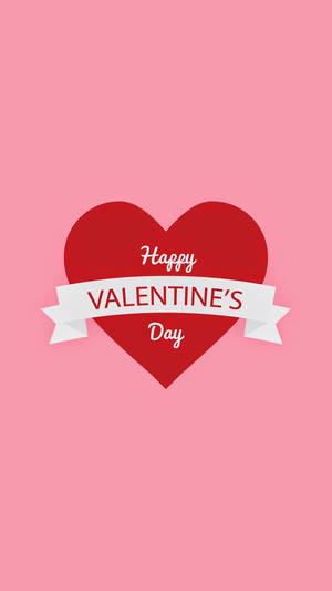 Gran corazón rojo con texto que dice "Feliz Día de San Valentín" en el centro sobre fondo rosa.