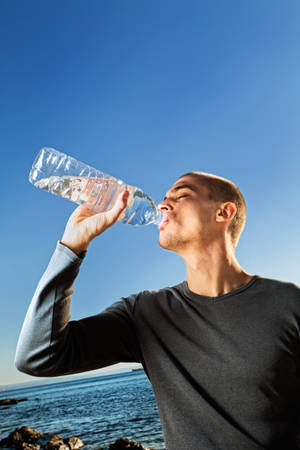 Hombre bebiendo agua de una botella
