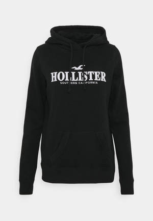 Fondo de pantalla de la chaqueta con capucha negra minimalista de Hollister — Limpio Fondos de pantalla
