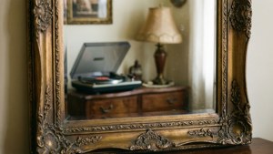 Un espejo vintage ornamentado que refleja un interior retro acogedor. — Estética retro Fondos de pantalla