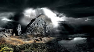 un paisaje oscuro con cielo tormentoso y rocas