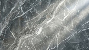 Elegante textura de mármol gris y blanco con intrincadas vetas onduladas.